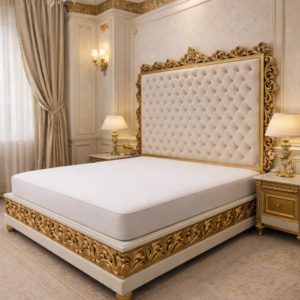 Handcrafted luxury teakwood bed featuring ornate gold carving, tufted upholstered headboard, and royal classic bedroom interior.
